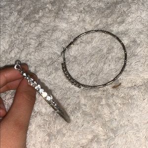 Silver hoop earrings with criss cross pattern gems